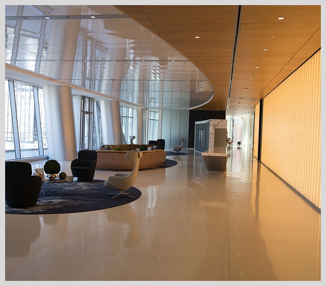 Modern office lobby with large windows, seating areas, glossy floors, and a long illuminated wall on the right side—an ideal backdrop for professional legal headshots.
